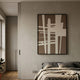 Deralin Mocha Grid Abstract 3D Carving Wall Art in a black frame, mounted on a textured grey bedroom wall above a linen-dressed bed.