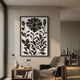 Florentia II Black & White Wood Carving 3D Wall Art by Giant Sculptures displayed above a console in a neutral living room beside a grey armchair.