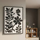 Florentia I Black & White Wood Carving 3D Wall Art by Giant Sculptures, displayed on a pale wall beside a wooden bookshelf with vases and a lamp.
