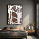 Drosan Earth Trace I Wood Carving 3D Wall Art with white organic linework on brown, framed in black above a bed with grey and peach linens.
