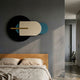 Orbitale Blue & Cream Geometry Wood Carving 3D Wall Art by Giant Sculptures mounted above a wooden bed with linen bedding in a grey bedroom.