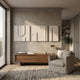 Moro II Triptych Sandstone Relief 3D Wall Art by Giant Sculptures mounted above a walnut console in a neutral living room with a linen armchair and olive tree.