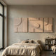 Giant Sculptures Moro I Triptych Sandstone Relief 3D Wall Art in beige, hung above a linen-dressed bed in a minimalist bedroom with a bookshelf alongside.
