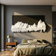 Riftline Ridgecut Charcoal Wood Carving 3D Wall Art mounted on a charcoal panel above a bed with olive linens, walnut nightstand and brass lamp alongside.