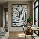 Dunari Midnight Trace I Wood Carving 3D Wall Art with black abstract linework on a textured white ground, displayed above a wooden desk beside a fiddle leaf fig.
