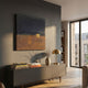 Kora Night Horizon 3D Wall Art by Giant Sculptures displayed above a grey sideboard with design books, a vase, and a brass lamp in a modern living room.