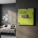 Kora Lime Ridge Folded 3D Wall Art by Giant Sculptures displayed on a dark grey bedroom wall beside a bed with grey linen and framed photos.