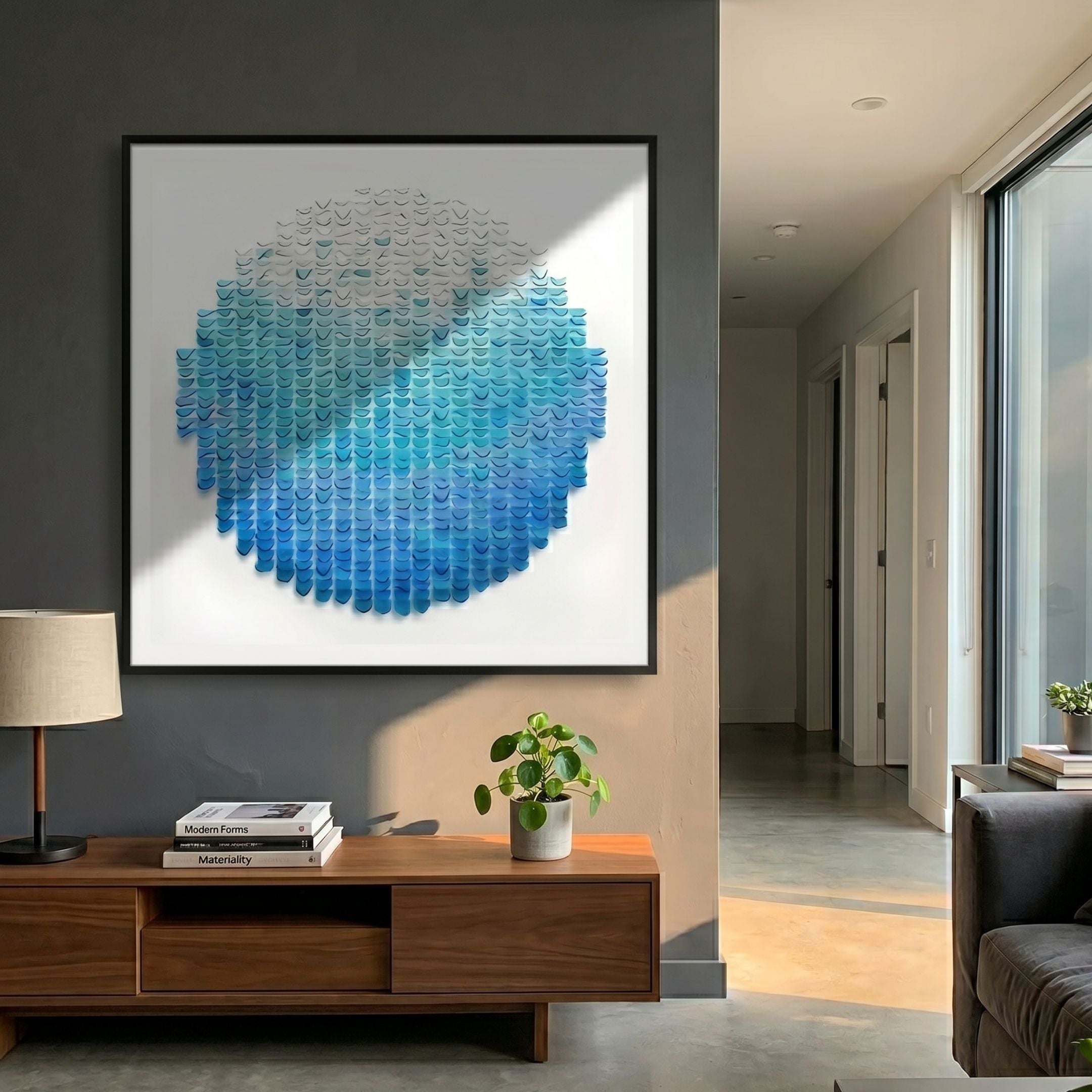 Montava Sky Blue Gradient Round Acrylic 3D Wall Art displayed above a wooden console with lamp and plant in a modern grey hallway.