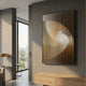 Cyclastra Amber Optical Spiral Acrylic 3D Wall Art by Giant Sculptures mounted on a grey wall in a modern interior with wooden sideboard and city-view window.