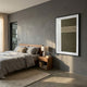 Trivaro Brown Panel III Wood Carving 3D Wall Art by Giant Sculptures, framed in black and hung above a wooden nightstand in a grey-toned bedroom.
