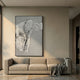 Ravelle Grey Contour Felt 3D Relief Wall Art by Giant Sculptures in a black frame, displayed above a beige sofa with a grey throw in a sunlit living room.