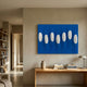 Virello Royal Blue & White Disc Leather 3D Wall Art by Giant Sculptures displayed above a wooden console table in a neutral living room with bookshelves.