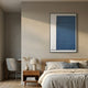 Trivaro Blue Panel I Wood Carving 3D Wall Art by Giant Sculptures displayed above a wooden nightstand in a neutral bedroom with linen bedding and a chair.
