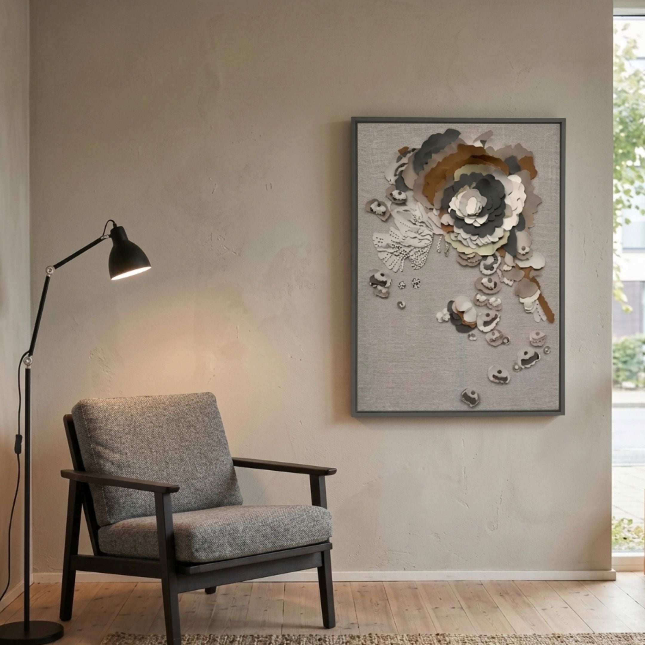 Floraxa Neutral Bloom Layered Leather 3D Wall Art in taupe, ivory, olive and grey, displayed above a grey armchair and black floor lamp in a living room.