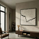 Virelline White & Black Layered Paper 3D Wall Art by Giant Sculptures, framed in black above a walnut console in a minimalist living room with a leather chair.