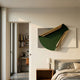 Valmeris Emerald Fold Sculptural Metal 3D Wall Art with curved emerald and gold iron form on grey and ivory leather panels, mounted in a modern bedroom.