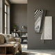 Urbis Black & White Vortex Chain Leather 3D Wall Art by Giant Sculptures displayed on a dark grey wall in a modern living room with a beige sofa and bookshelf.