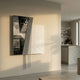 Urbis Black & White Skyline Chain Leather 3D Wall Art by Giant Sculptures, mounted on a pale wall beside a modern kitchen with concrete island and open shelving.