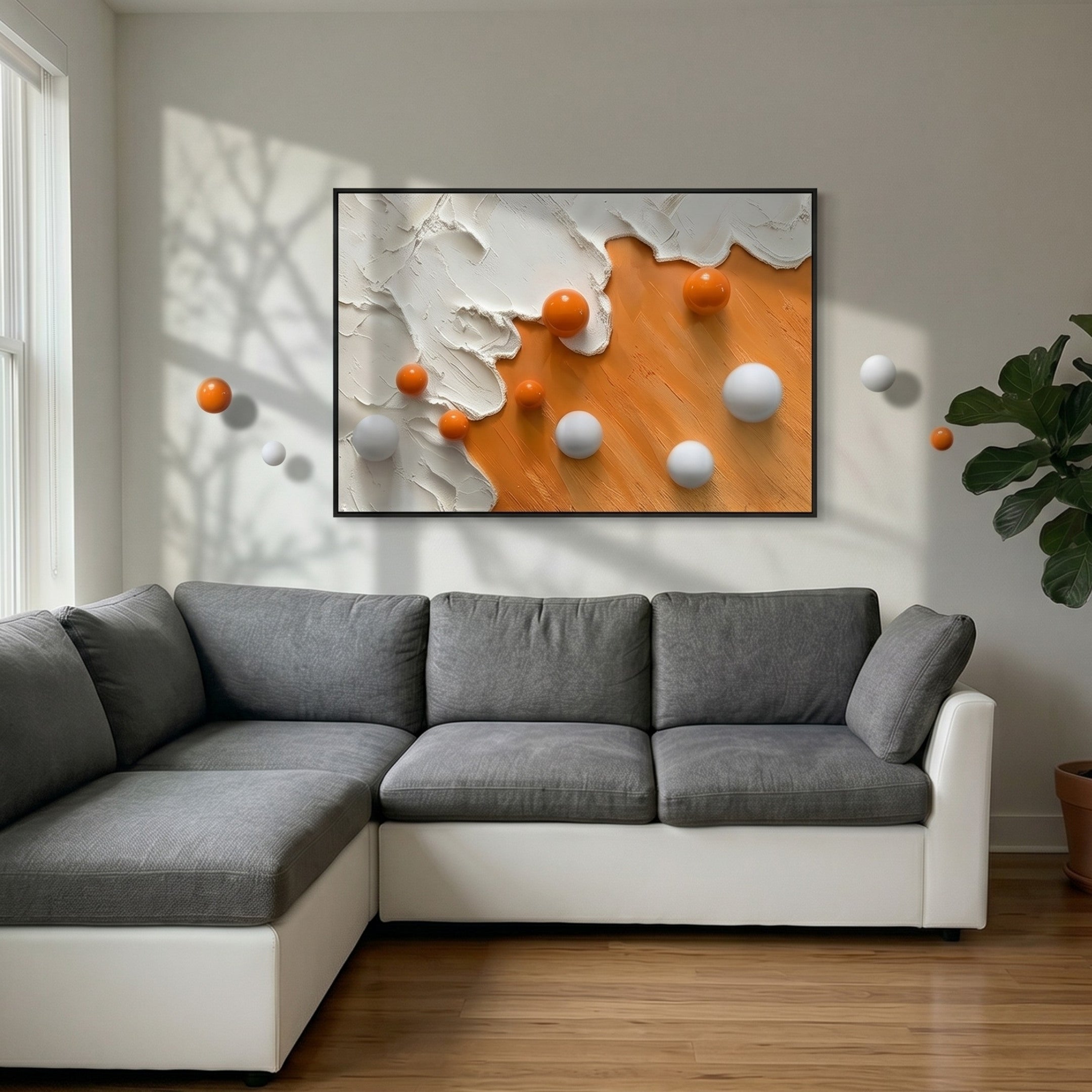 A modern living room with a gray and white sectional sofa, a Tideborne White & Orange Texture Horizontal 3D Wall Art With Metal Balls by Giant Sculptures, and a green potted plant. Sunlight casts dramatic shadows on the wall.
