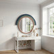 A white desk with a lamp, books, and decor sits against floral wallpaper and the Arcaluna Navy & Green Layered Round Mirror 3D Wall Art by Giant Sculptures, framed by pastel rainbow arches. Large windows fill the cozy modern room with natural light.