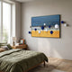 Aerisphere Coastal Horizon 3D wall art by Giant Sculptures, with blue and white metal spheres on a yellow and blue landscape canvas, displayed above a green-linen bed.