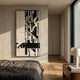 Lintrix Tall Black & White Geometric Woollen Knit 3D Wall Art mounted on a cream bedroom wall above a linen-dressed bed beside a hallway and nightstand.