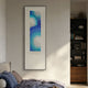 Glaciera Cerulean Mint Silver Acrylic 3D Wall Art by Giant Sculptures, framed vertically above a bed beside a dark bookshelf in a contemporary bedroom.