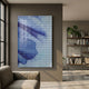 Lattice Indigo Fade Acrylic 3D Wall Art by Giant Sculptures mounted on a taupe wall in a modern living room with a linen sofa, bookshelf, and plants.