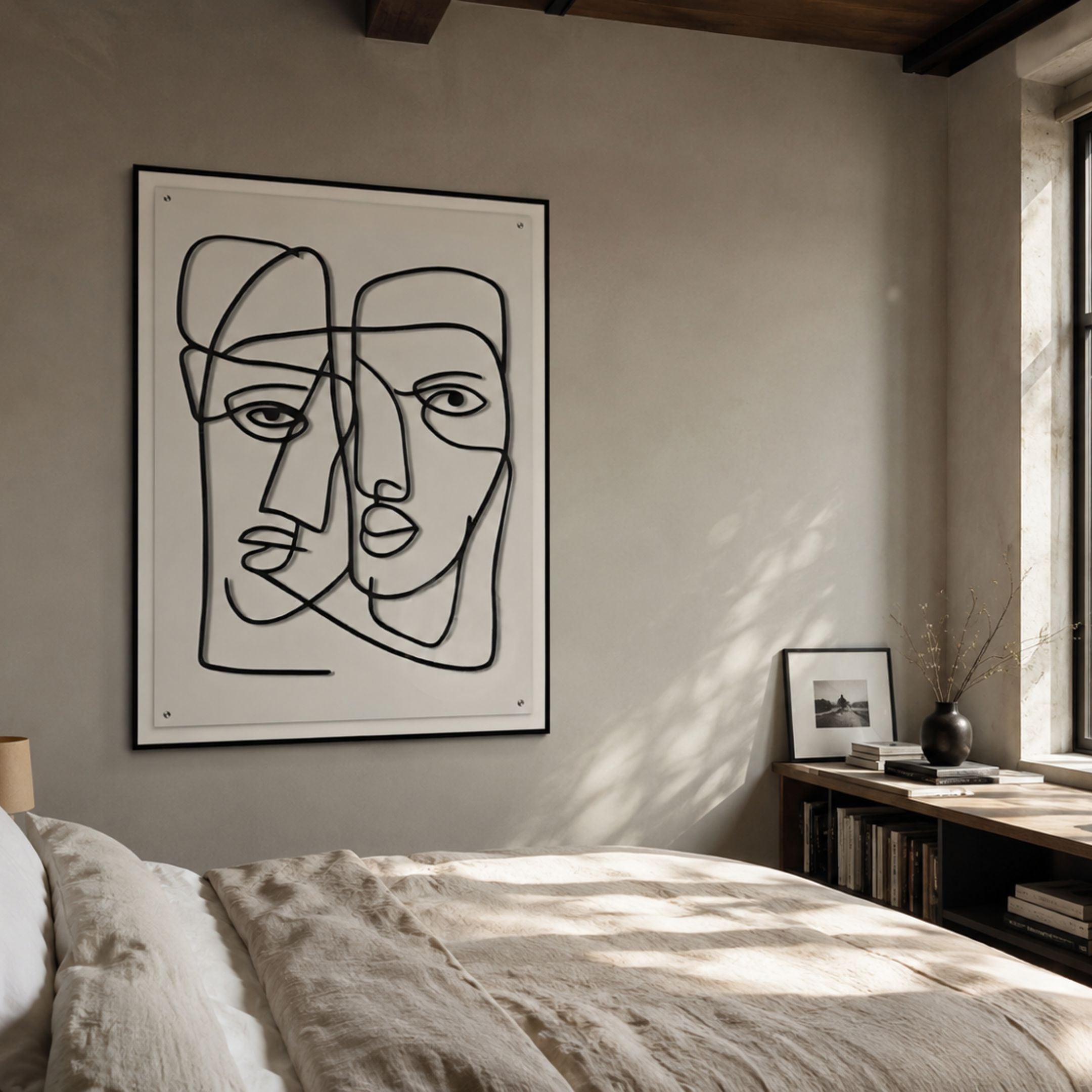 Linea Couple Faces Minimal Acrylic UV 3D Wall Art mounted above a linen-dressed bed in a sunlit bedroom with a low bookshelf beside a window.