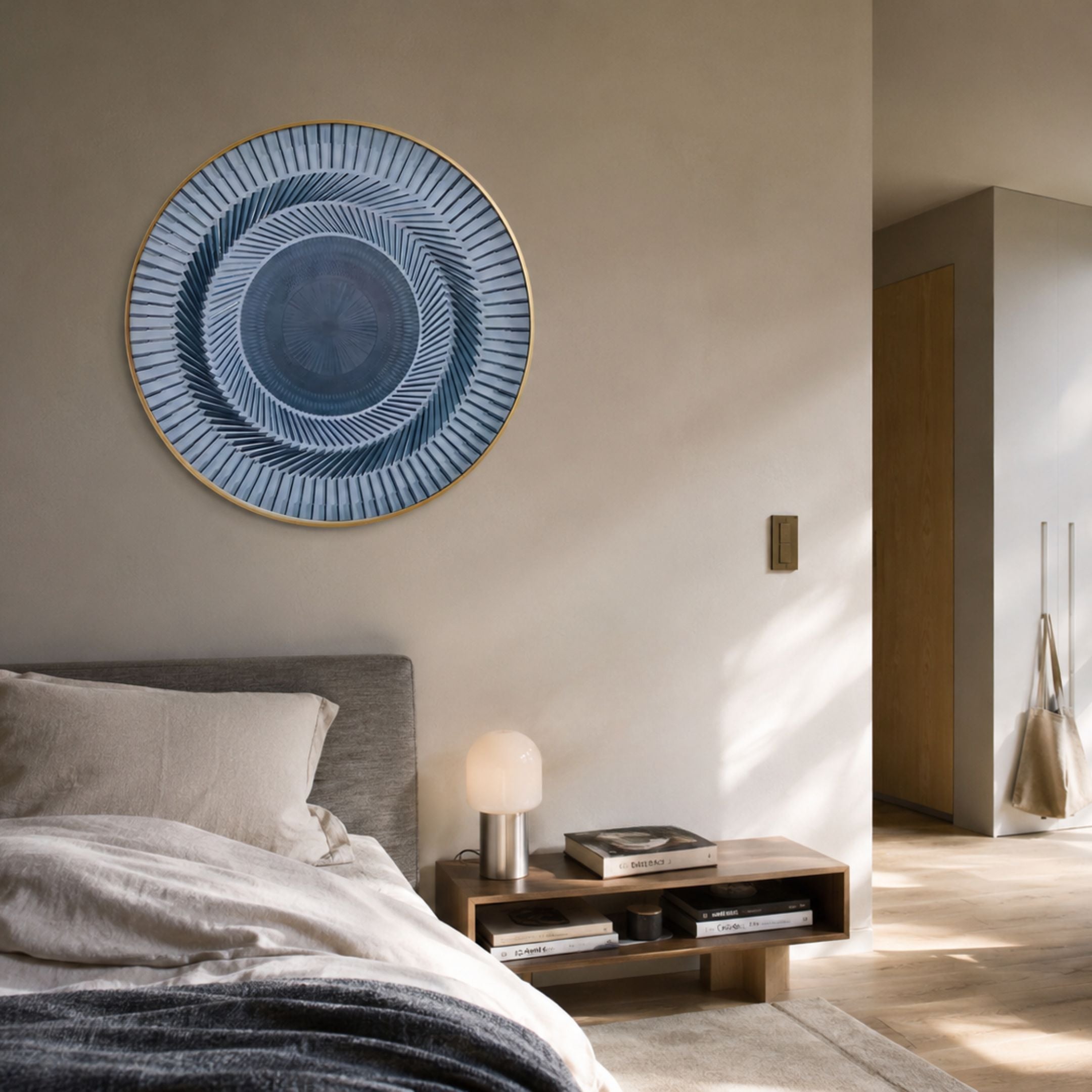 Helix Blue Spiral Illusion Acrylic 3D Wall Art in a gold round frame, mounted above a wooden bedside console in a neutral-toned bedroom.