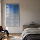 Flux Sapphire Blue Gradient Illusion Acrylic 3D Wall Art by Giant Sculptures displayed in a neutral bedroom above a wooden bench, beside a linen-dressed bed.