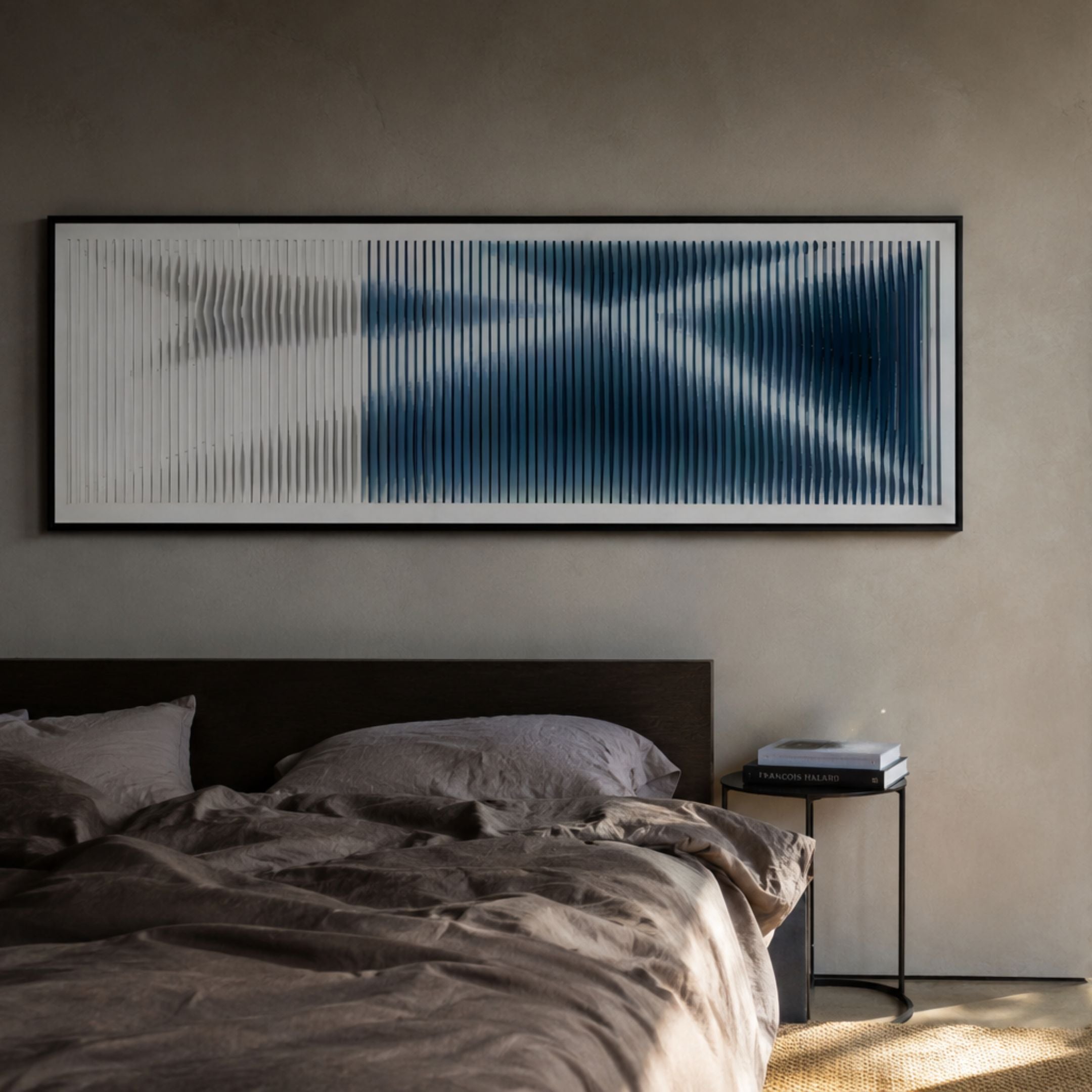 Kinetix Deep Indigo & White Optical Flow Acrylic 3D Wall Art mounted above a dark wood bed with linen bedding and a black side table.