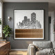 Urban Rise Bronze Skyline Acrylic 3D Wall Art by Giant Sculptures displayed on a grey living room wall above a sofa, beside a fiddle leaf fig and walnut sideboard.