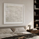 Terraform Grid Relief Paper 3D Wall Art in a white frame above an upholstered bed, beside a walnut bookshelf and mushroom lamp in a neutral bedroom.