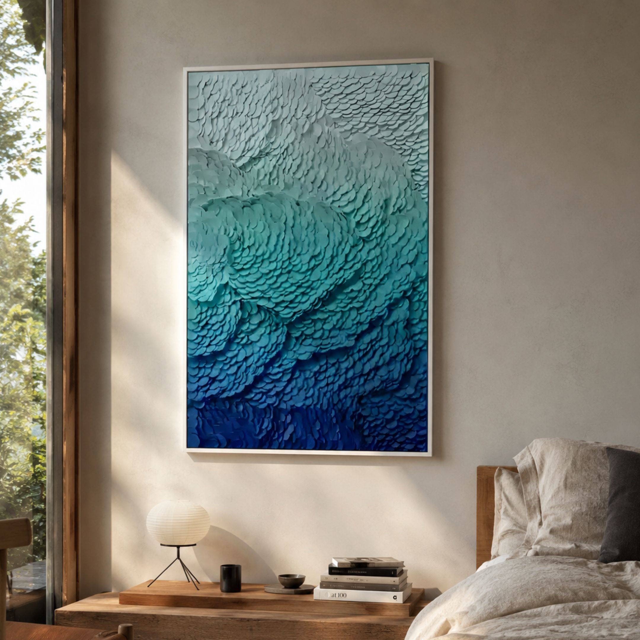 Petalwave Teal Gradient Blossom Flow Leather 3D Wall Art in a framed ice-blue to navy ombre, hung above a wooden bedside table with paper lamp.
