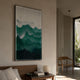 Mistline Emerald Mountain Scene Acrylic 3D Wall Art by Giant Sculptures mounted above a wooden bedside table in a sunlit minimalist bedroom with a wooden chair.
