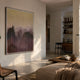 Mistline Amber Dusk Mountain Scene Acrylic 3D Wall Art by Giant Sculptures mounted in a sunlit modern living room with wood coffee table and bookshelves.