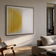 Halcyon Gold Fade Lens Acrylic 3D Wall Art by Giant Sculptures mounted in a sunlit modern living room above a wooden chair and textured sofa.