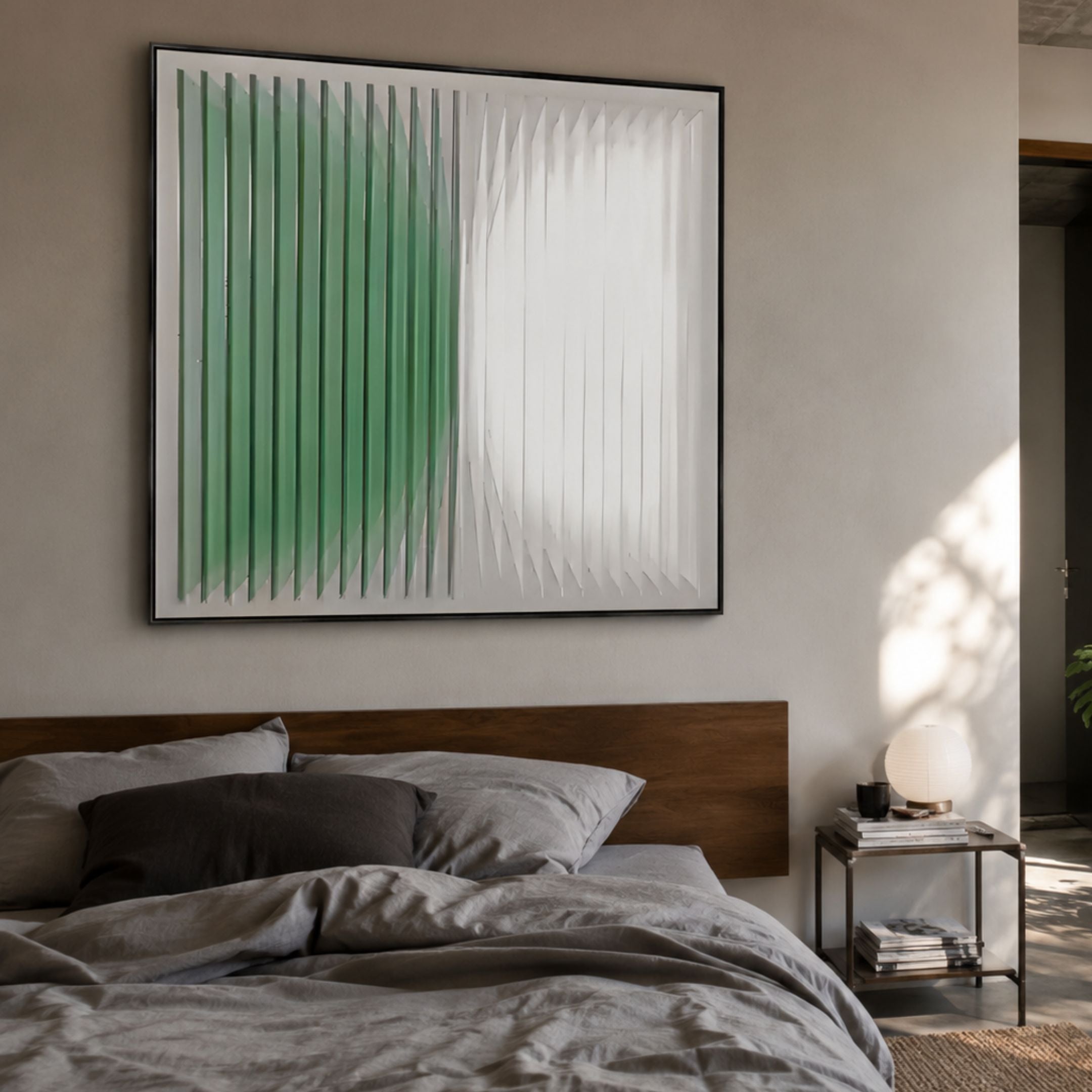 Halcyon Mint Fade Lens Acrylic 3D Wall Art by Giant Sculptures in a black frame above a wooden bed with grey linens and a globe lamp on a side table.