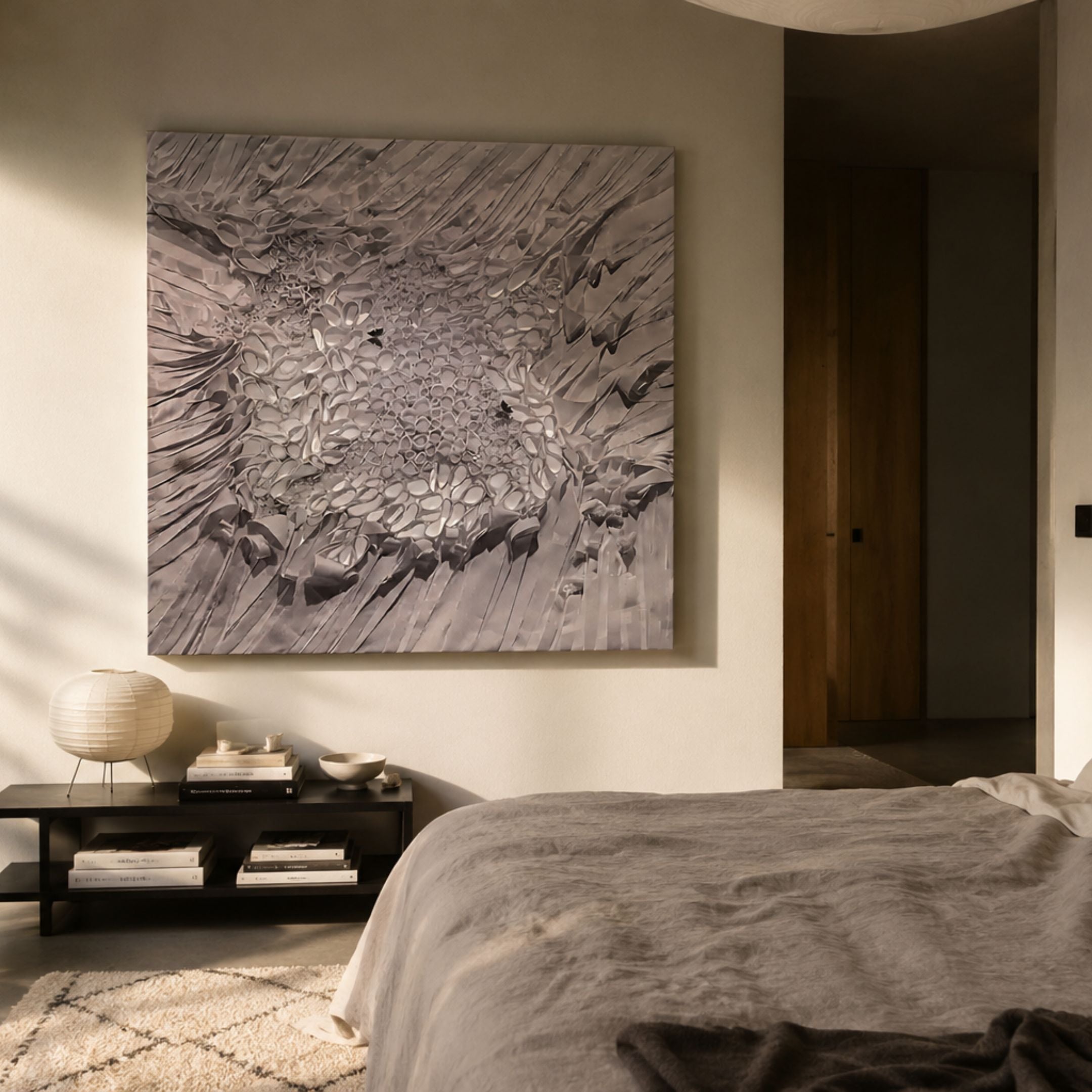 Velorra Dusty Lavender Bloom Ribbon Frameless 3D Wall Art mounted above a black console in a warm-toned bedroom with paper lantern lamp and linen bedding.