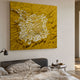 Velorra Golden Honey Bloom Ribbon Frameless 3D Wall Art mounted above a grey upholstered bed with linen bedding and a round side table in a warm bedroom.