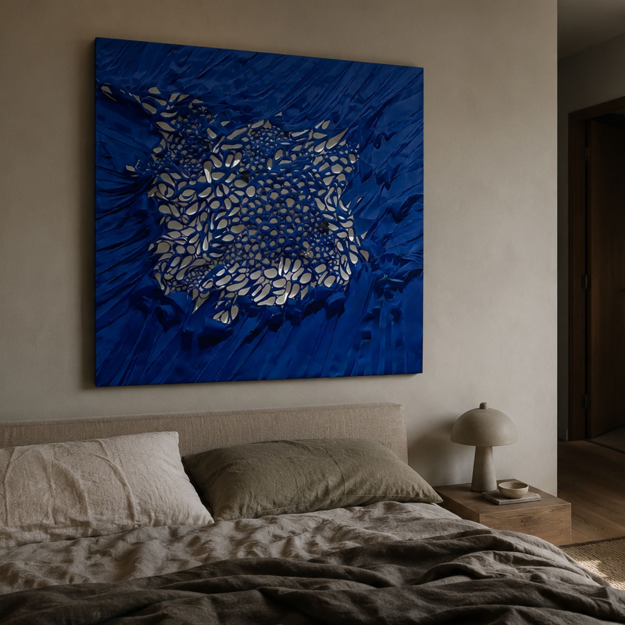Velorra Royal Blue Bloom Ribbon Frameless 3D Wall Art mounted above a linen bed with olive pillows and a mushroom lamp on a wooden nightstand.