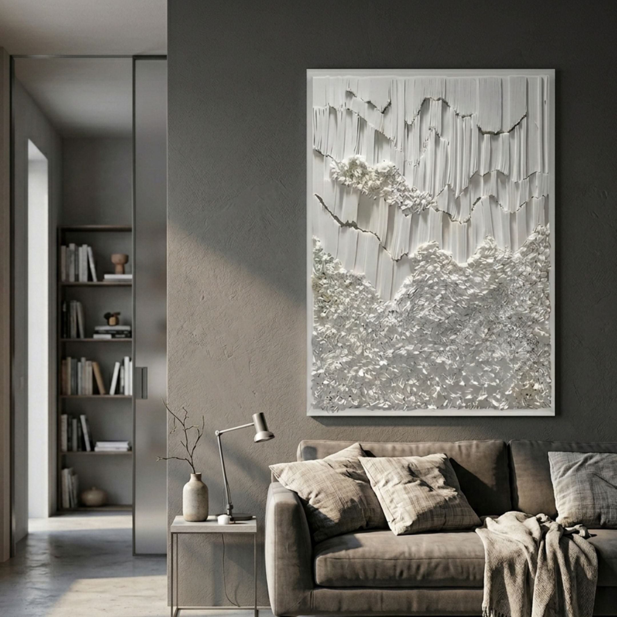 Tessara Ivory Organic Drape Felt 3D Wall Art displayed above a taupe sofa in a modern grey living room with bookshelf and side table.