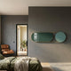 Modvara Solid Sky Blue Fusion Acrylic & Leather Wall Art by Giant Sculptures, mounted on a grey bedroom wall beside a tan leather lounge chair and doorway.