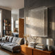 Artisana White Grid 3D Paper Wall Art by Giant Sculptures in an acrylic case, mounted above a teak sideboard in a modern living room with grey sofa.