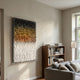 Vistra Black, Amber & White Ombre Ruffled 3D Paper Wall Art in an acrylic box frame, mounted in a sunlit living room beside a wooden bookshelf and grey sofa.