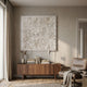 Floravia I White Ruffled Left Leather 3D Wall Art by Giant Sculptures displayed above a walnut sideboard with books and dried grasses in a neutral living room.