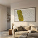 Fractura Sunlit Yellow Wide 3D Acrylic Wall Art by Giant Sculptures displayed above a beige sofa in a sunlit minimalist living room with bookshelves.