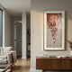 Flourish I Red Flower Sawdust 3D Wall Art by Giant Sculptures displayed in a neutral living room above a walnut sideboard, with cascading red-orange blooms on a white grid in a gold frame.
