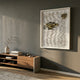 Monovista Frost White & Gold Acrylic Box 3D Paper Wall Art mounted on a grey wall above a walnut media console with vase and books in a modern living room.